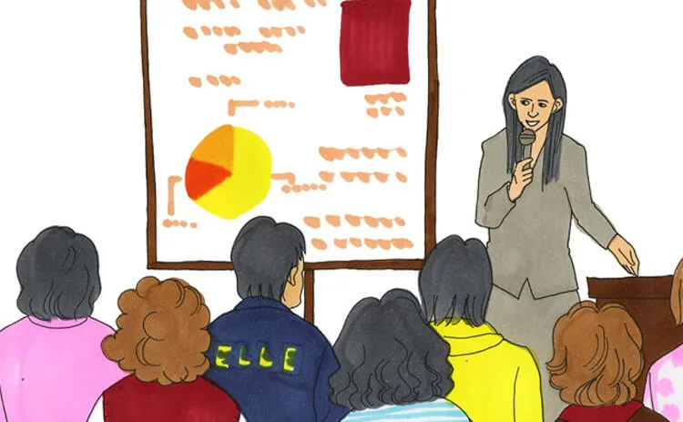 A long-haired speaker in gray holds a microphone before six audience members seen from behind. A chart appears behind the speaker, and ELLE is written on one audience member’s blue clothing.